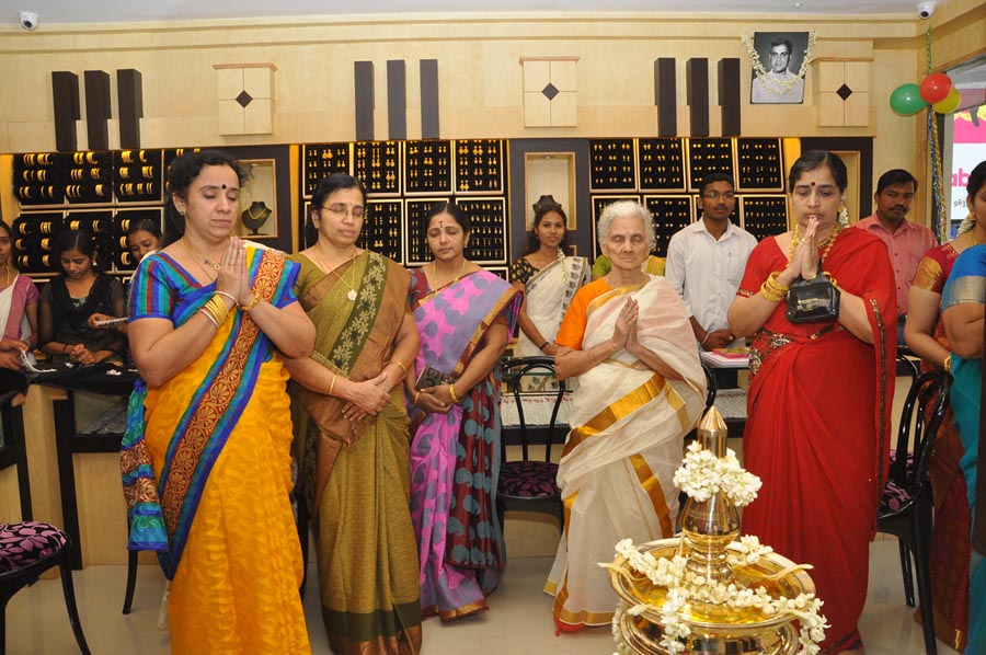 The family and guests gathered in prayer at the lamp inside the showroom