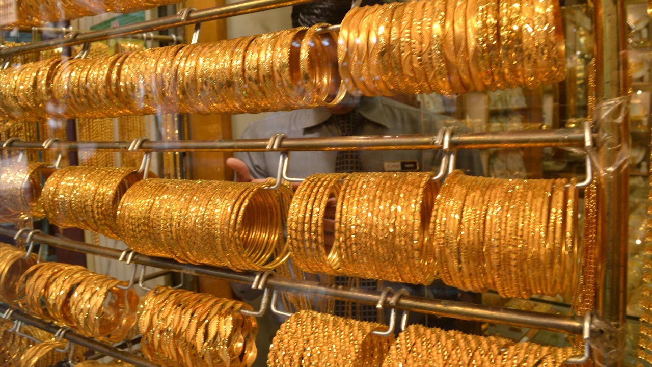 Hand-crafted gold bangles on the wall at Balakrishna · Stadium